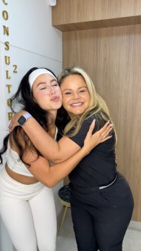 Dr. Yasmín Escudero hugging a patient after smile transformation with veneers in Medellín, Colombia.